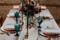 23 teal cnadles and glasses and copper chargers and flatware look very chic and embrace the fall