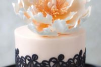 24 a blush and black lace mini cake with an open peony on top for a glam wedding