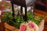 25 a pallet box with greenery, flowers and a black metal candle lantern for a rustic wedding