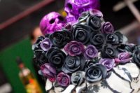 25 black, white and purple wedding cake with purple glitter skulls on top