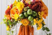 26 a bold centerpiece with carrots, cabbages, radish and yellow and orange flowers for a fall wedding