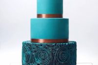 26 a teal wedding cake with a ruffle rose layer and copper ribbons