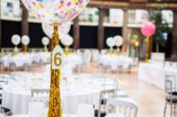 26 transparent balloons with colroful confetti inside and gold fringe for a centerpiece