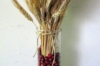 26 wheat and cranberry glass jar centerpiece for a fall wedding