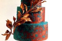 27 artsy wedding cake decorated with matte copper and teal plus a copper leaf branch