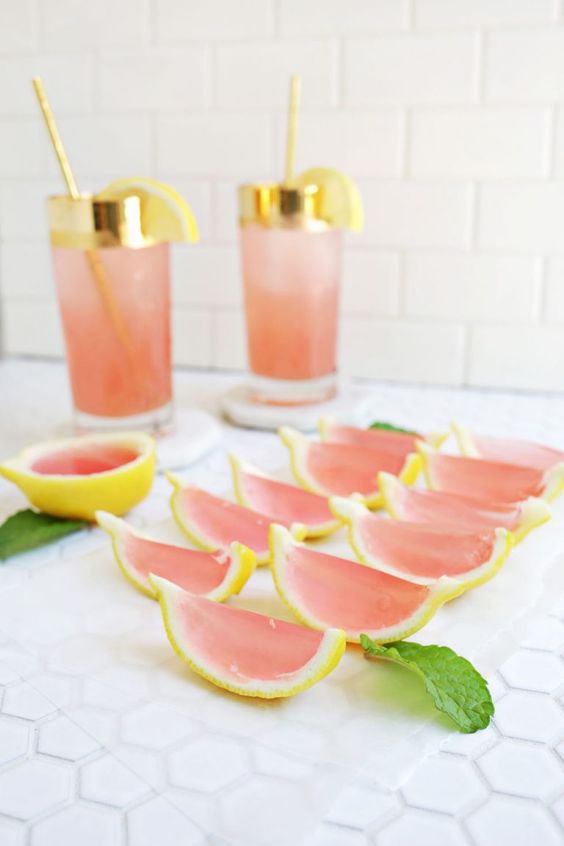 pink jello shots shaped as citrus slices look cute and taste nice