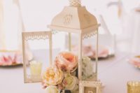 28 a Morocco-style lantern with a pastel floral arrangement and a small framed table number