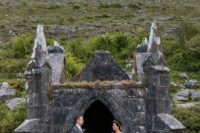 29 a couple pictured in an Irish castle courtyard that looks vintage and beautiful