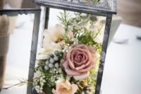 29 a shabby chic dark metal lantern with a textural floral arrangement looks chic and unusual