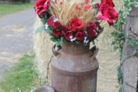 29 an old milk churn with red roses, greenery and wheat is awesome for any rustic celebration