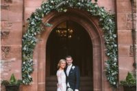 30 a couple at the entrance to Peckforton Castle right after their ceremony
