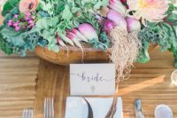 30 a wooden bowl with radish, onions, artichokes, wildflowers for a farm-to-table wedding