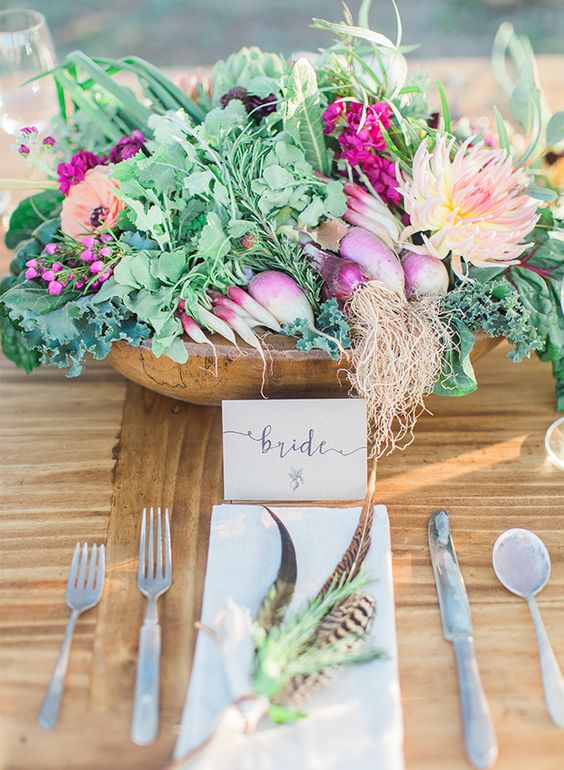 a wooden bowl with radish, onions, artichokes, wildflowers for a farm-to-table wedding