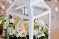 31 a white lantern with fresh neutral blooms can become a great base for any wedding centerpiece