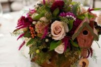a bold wedding centerpiece of a wooden box, blush and fuchsia blooms, greenery and seed pods is amazing