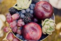 a chic centerpiece with grapes, plums, blackberries, blueberries and succulents in a bowl
