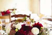 a fall wedding centerpiece of a stained box, burgundy, white and blush blooms and some leaves