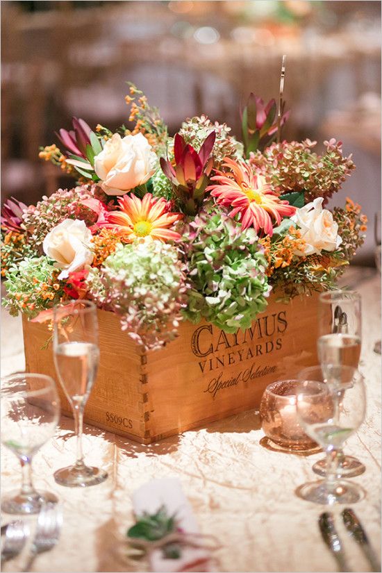 a lovely and bright wedding centerpiece of a wooden box with green, blush and burgundy blooms is a catchy decor idea