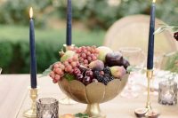 a metallic bowl with fresh fruit and black candles are a gorgeous combo for a decadent fall wedding