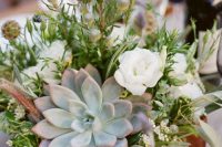 a pretty wedding centerpiece of a box with greeneyr, white blooms, succulents and billy balls is a stylish idea