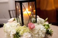 a reclaimed wooden box with various blooms and a candle lantern will add coziness to your interior