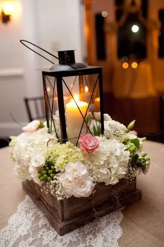 a reclaimed wooden box with various blooms and a candle lantern will add coziness to your interior