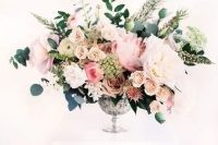 a super lush and textural floral centerpiece with blush, pink and white blooms, herbs and greenery