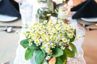 a wooden planter with daisies and some foliage is a cute and bright solution for a laid-back summer wedding