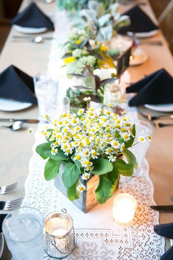 a wooden planter with daisies and some foliage is a cute and bright solution for a laid-back summer wedding