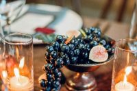 an affordable decadent wedding centerpiece of a bowl with grapes and figs is amazing for a fall wedding