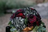 blood-red roses, black hydrangeas, seeded eucalyptus in a gold bowl for bold and dramatic look