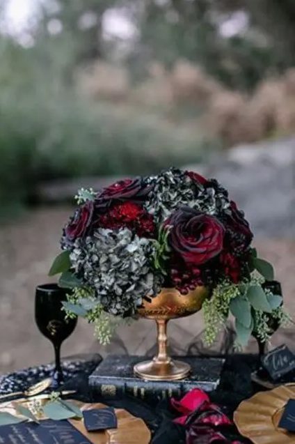 blood-red roses, black hydrangeas, seeded eucalyptus in a gold bowl for bold and dramatic look