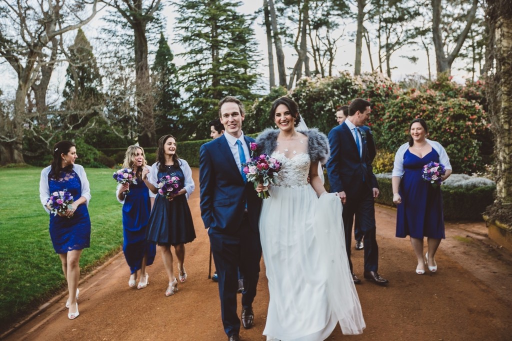 The bride was wearing a gorgeous lace bodice wedding dress, the bridesmaids were wearing cobalt blue dress, and guys were dressed in navy suits with matching ties