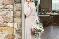 02 The bride was wearing an incredible shimmering wedding gown with long sleeves and a plunging neckline, accentuated with a metallic belt