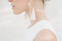 a quartz bridal headpiece and modern rhinestone and white tassel earrings