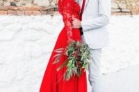 02 a red wedding dress with lace sleeves and bodice and a textural greenery bouquet