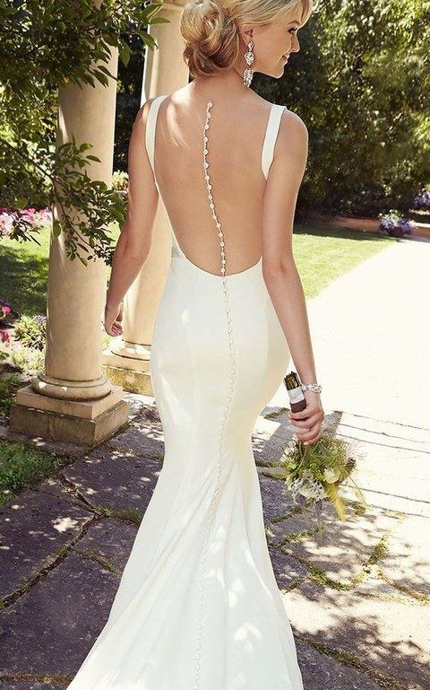 modern plain mermaid wedding dress with a sheer back and sparkling buttons on it