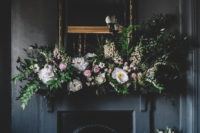 moody fireplace decorated with flowers