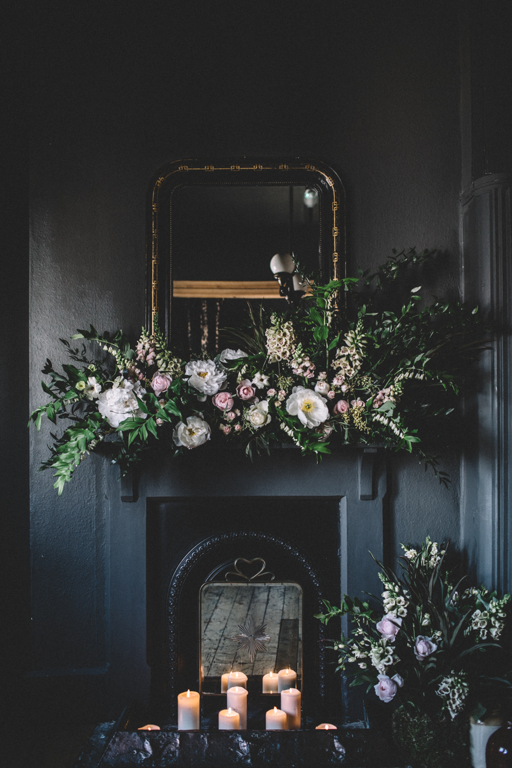 The fireplace was decorated with white and blush blooms and lush greenery