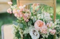 03 a birdcage with crystals, lush greenery and pink blooms for a garden wedding