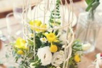 04 a birdcage with white and yellow blooms and foliage is cute and simple to make