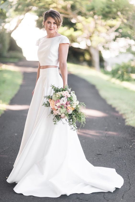 a modern plain two piece wedding dress with a train and cap sleeves