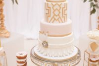 04 a white and gold wedding cake with geo decor, petals, beads, feathers and vintage brooches