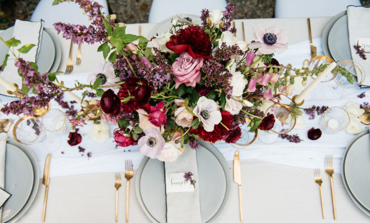 Matte grey plates and gold cutlery look heavenly beautiful with a statement centerpiece