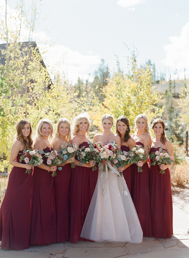The bridesmaids were wearing strapless burgundy gowns, which looked very fall-like