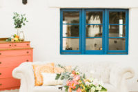 05 The wedding lounge was created with a white sofa, a copper table, citrus and bold blooms