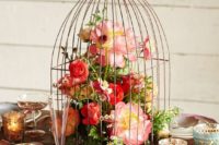 05 a vintage cage with lush red and pink blooms and greenery for a colorful wedding