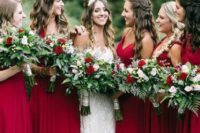 05 bridesmaids in chic red maxi dresses with textural greenery and red rose bouquets
