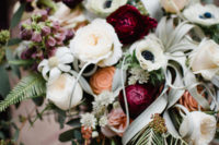 06 The bridal bouquet was lush, with textural greenery, neutrals and berry-hued blooms