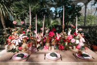 07 The bold tablescape was done with pink hues, gilded pineapples and tropical leaves, pink candles added glam